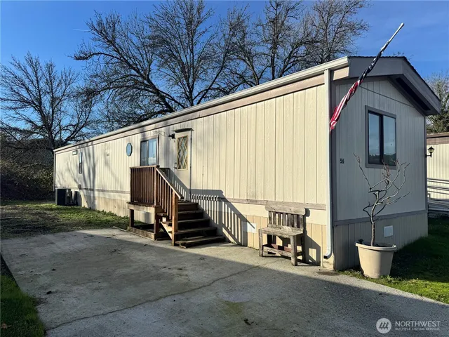 a view of a house with backyard and sitting area