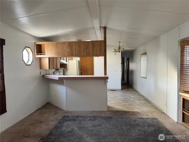 a view of kitchen with refrigerator and cabinets