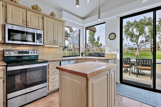 a kitchen with stainless steel appliances granite countertop a stove and a microwave