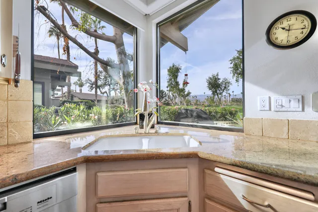 a kitchen with a large window cabinets and a counter top space