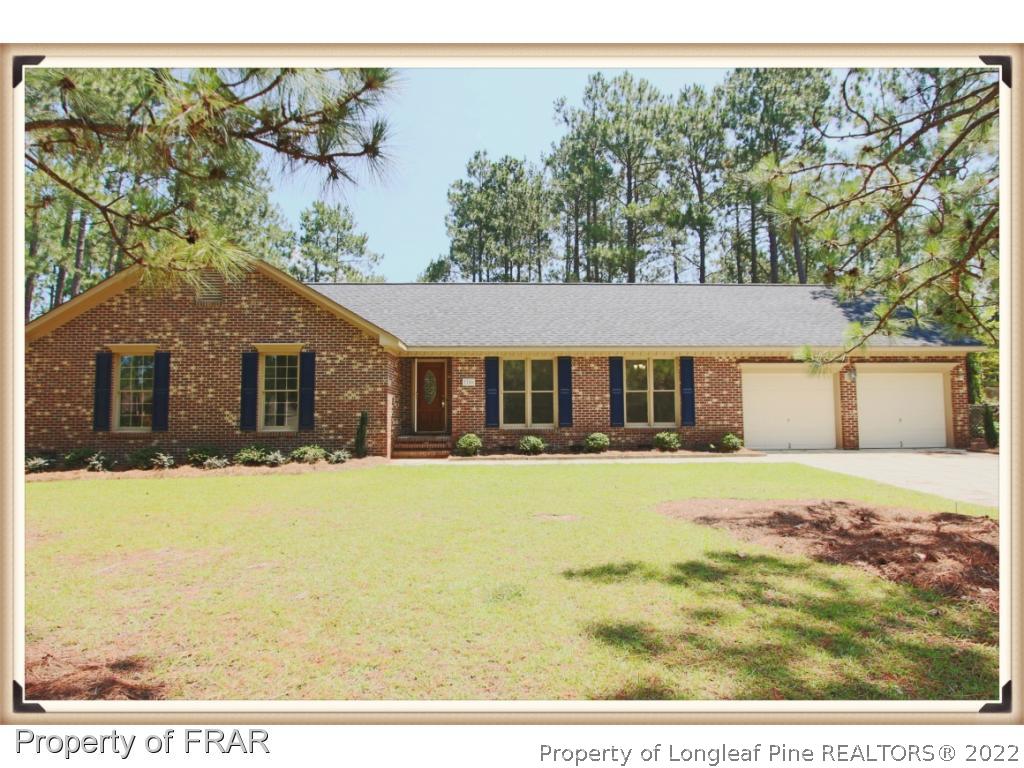 7786 Dragonhead Road Fayetteville, NC 28311 - Photo 1 of 33 a front view of a house with a yard