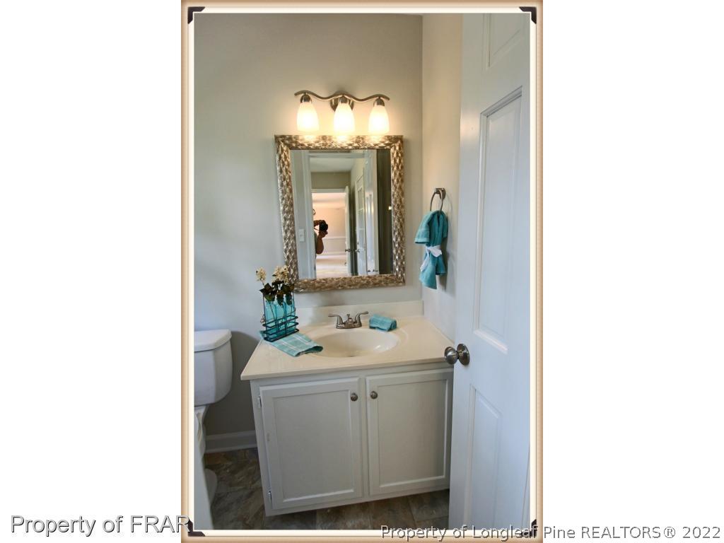 7786 Dragonhead Road Fayetteville, NC 28311 - Photo 13 of 33 a bathroom with a sink and a mirror