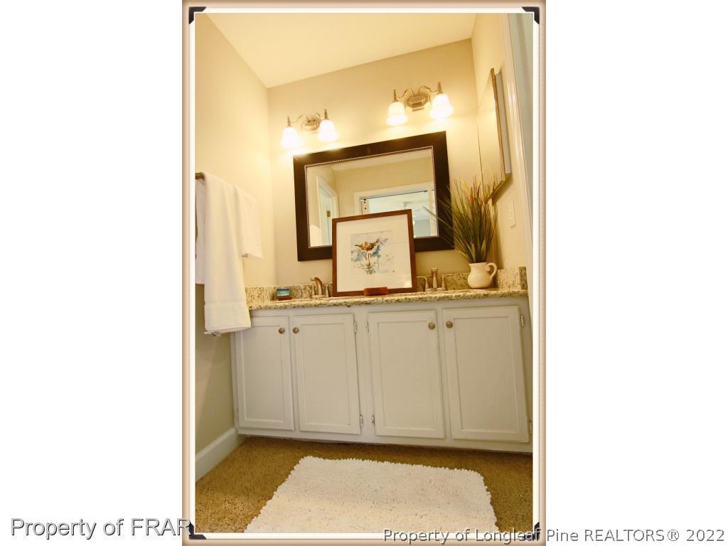 7786 Dragonhead Road Fayetteville, NC 28311 - Photo 27 of 33 a bathroom with a sink and a mirror