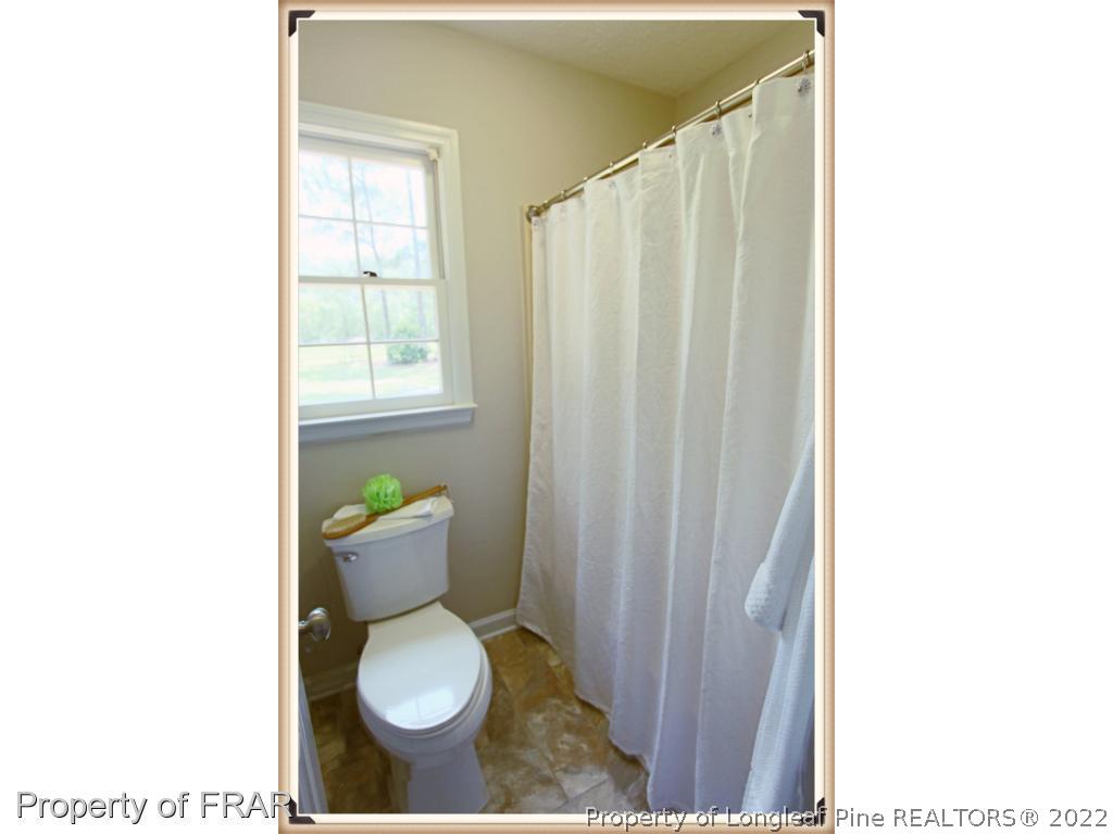 7786 Dragonhead Road Fayetteville, NC 28311 - Photo 29 of 33 a bathroom with a toilet and a sink