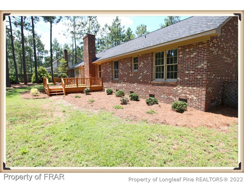7786 Dragonhead Road Fayetteville, NC 28311 - Photo 33 of 33 a view of a backyard with table and chairs and wooden fence
