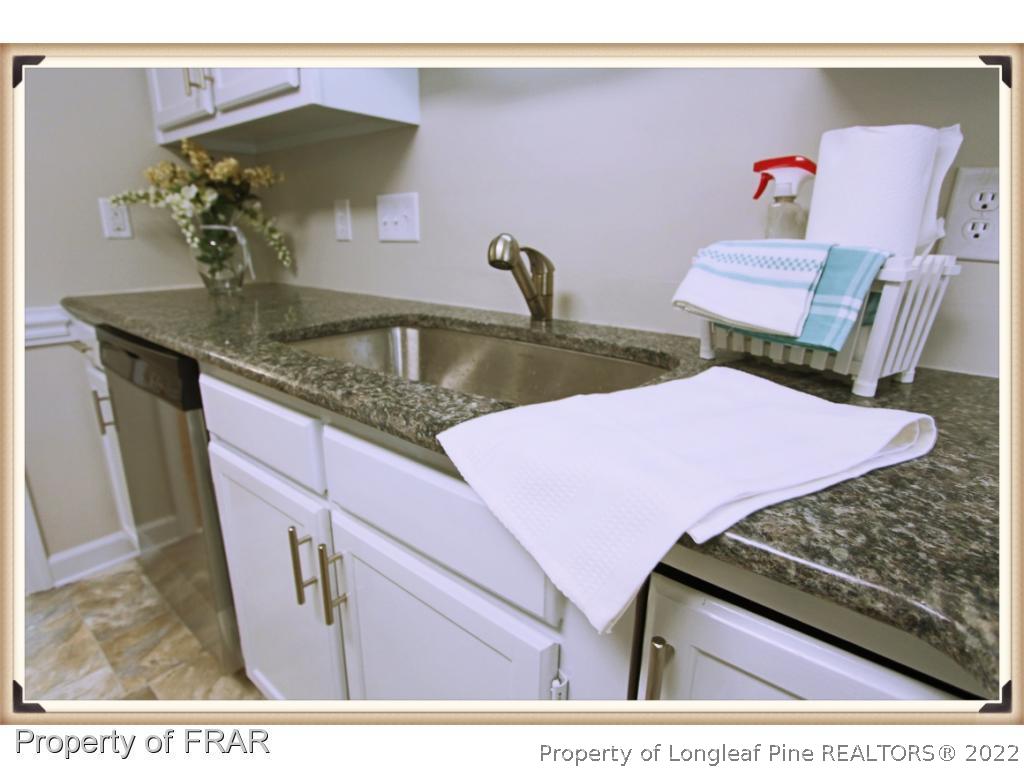 7786 Dragonhead Road Fayetteville, NC 28311 - Photo 7 of 33 a bathroom with a granite countertop sink and a mirror