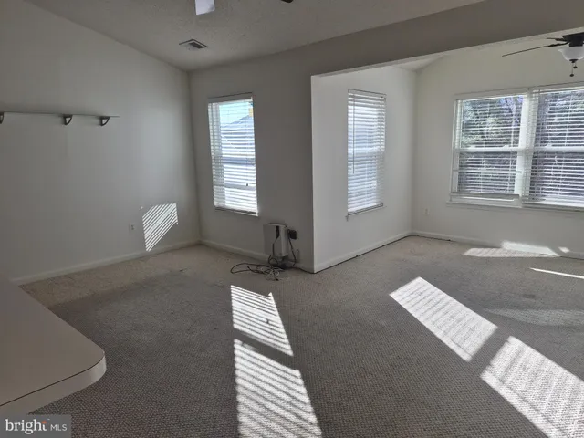 a view of an empty room with windows