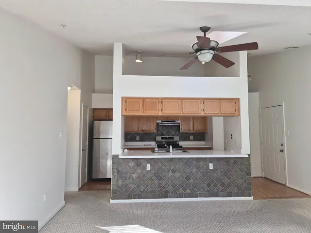 a view of a kitchen with a sink and cabinet