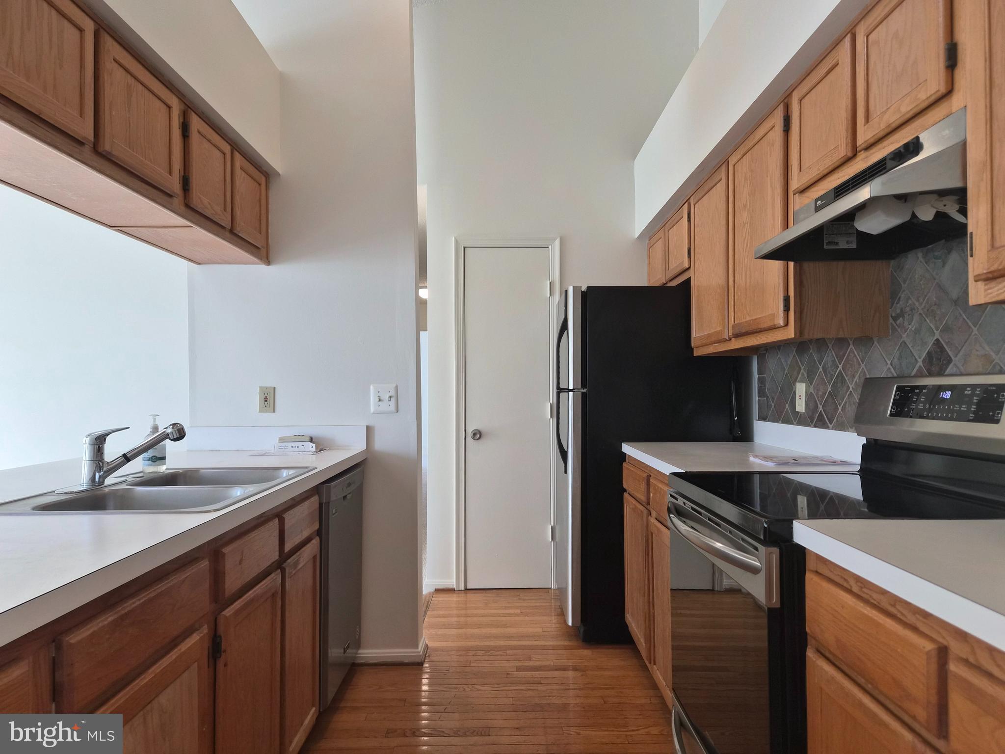 2706 Snowbird Terrace, Unit 1220 Silver Spring, MD 20906 - Photo 6 of 24 a kitchen with a sink and a refrigerator