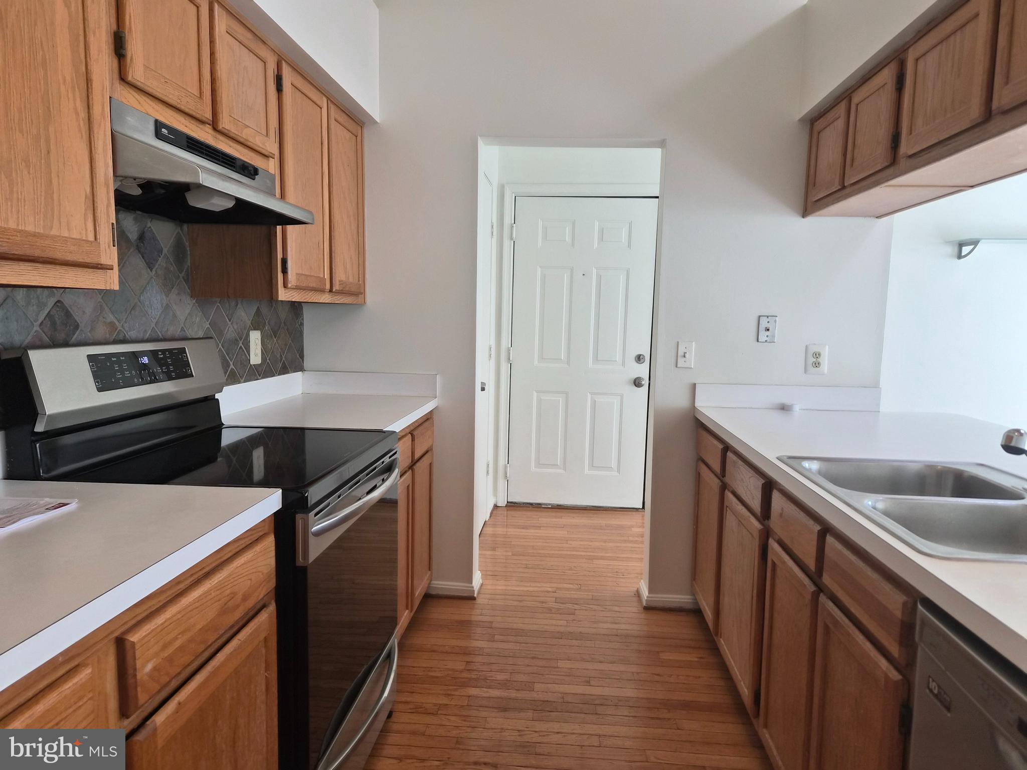 2706 Snowbird Terrace, Unit 1220 Silver Spring, MD 20906 - Photo 7 of 24 a kitchen with a sink and cabinets