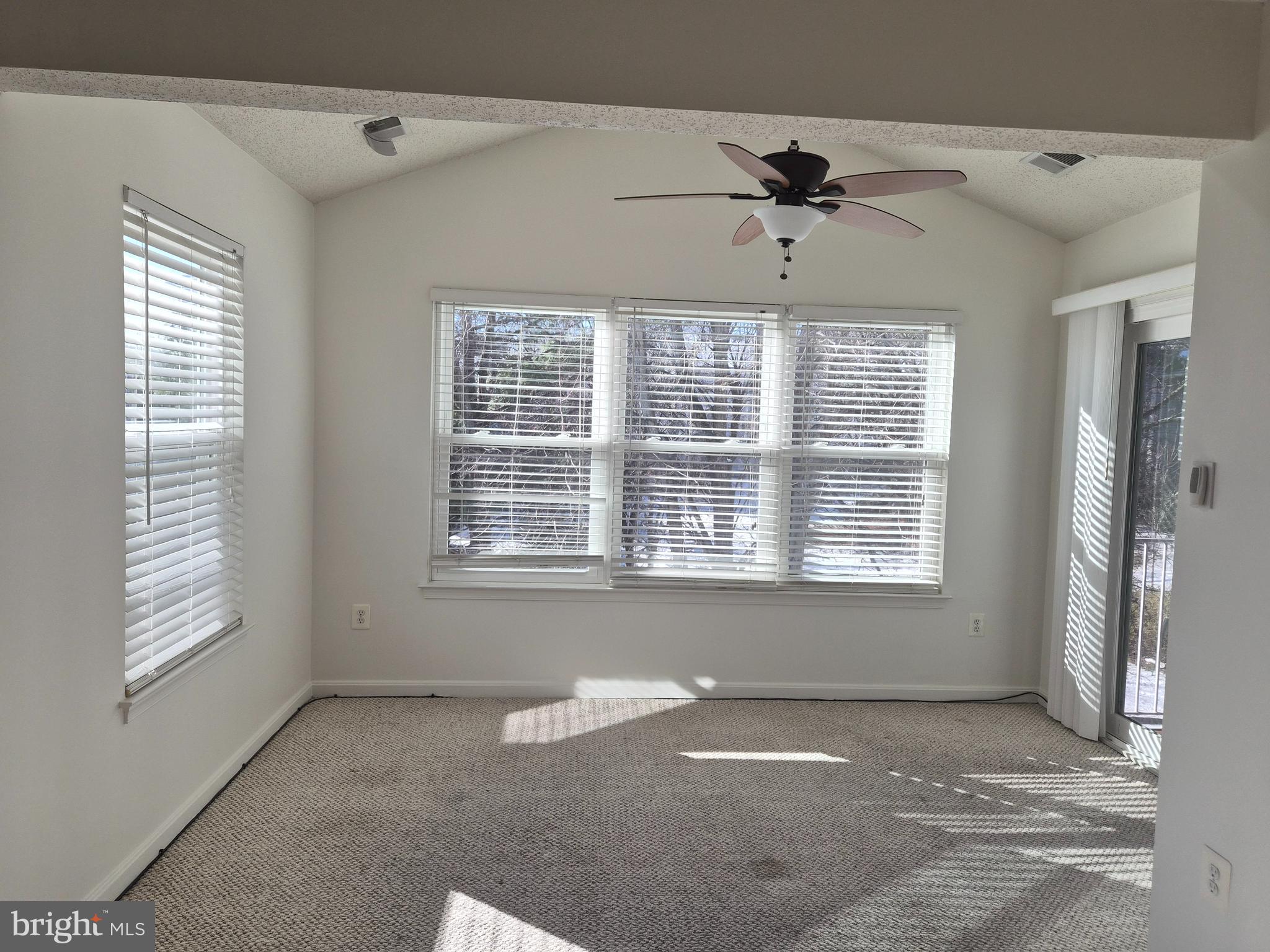 2706 Snowbird Terrace, Unit 1220 Silver Spring, MD 20906 - Photo 10 of 24 an empty room with windows and ceiling fan