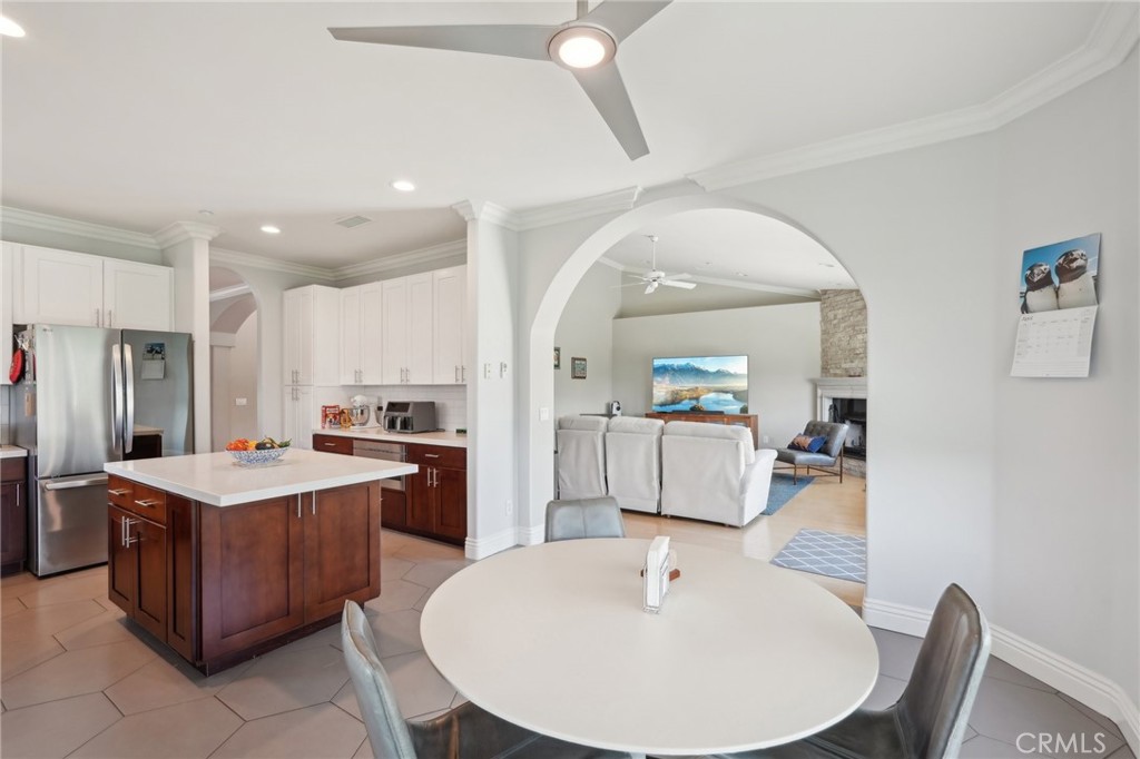 5965 Vía Loma Riverside, CA 92506 - Photo 16 of 41 a large kitchen with kitchen island a sink a stove a dining table and chairs
