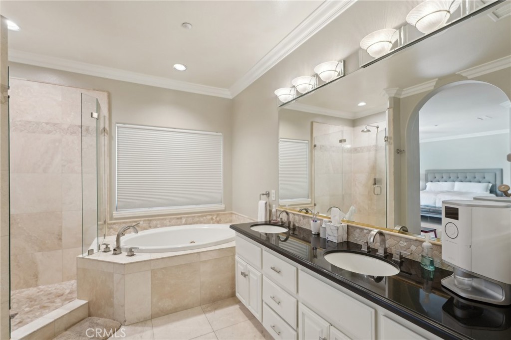 5965 Vía Loma Riverside, CA 92506 - Photo 20 of 41 a bathroom with a granite countertop tub sink and mirror