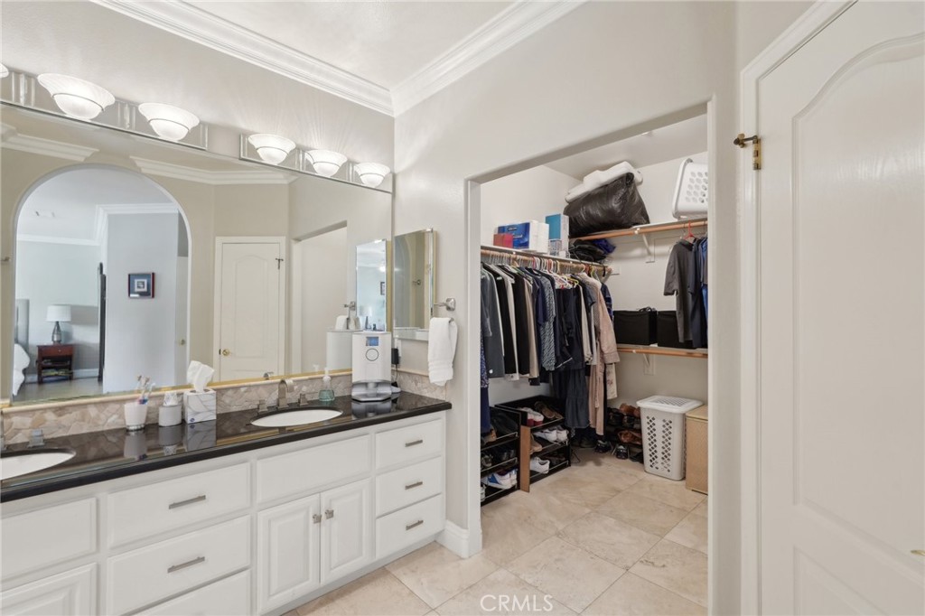 5965 Vía Loma Riverside, CA 92506 - Photo 21 of 41 a bathroom with a double vanity sink and a mirror