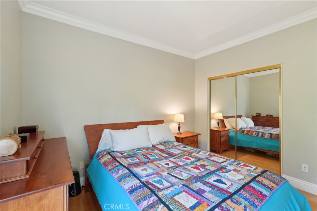 5965 Vía Loma Riverside, CA 92506 - Photo 29 of 41 a bedroom with a bed and wooden floor