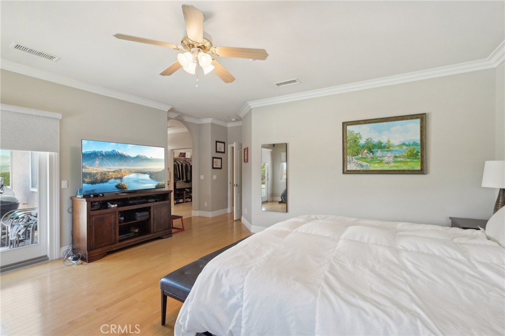 5965 Vía Loma Riverside, CA 92506 - Photo 31 of 41 a bedroom with a bed and a flat screen tv