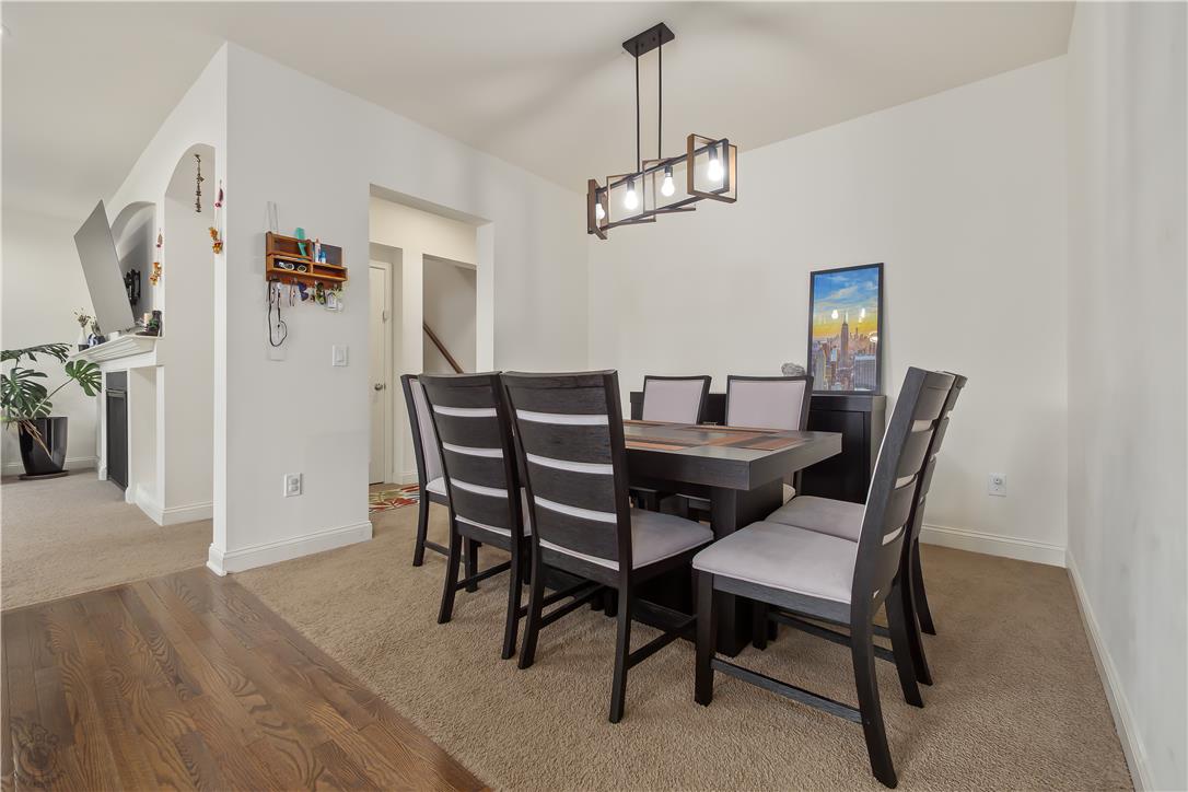 640 Rinaldi Lane Easton, PA 18040 - Photo 13 of 42 Dining area showcases carpeted flooring, a contemporary lighting fixture, and an open layout connecting to the living space.