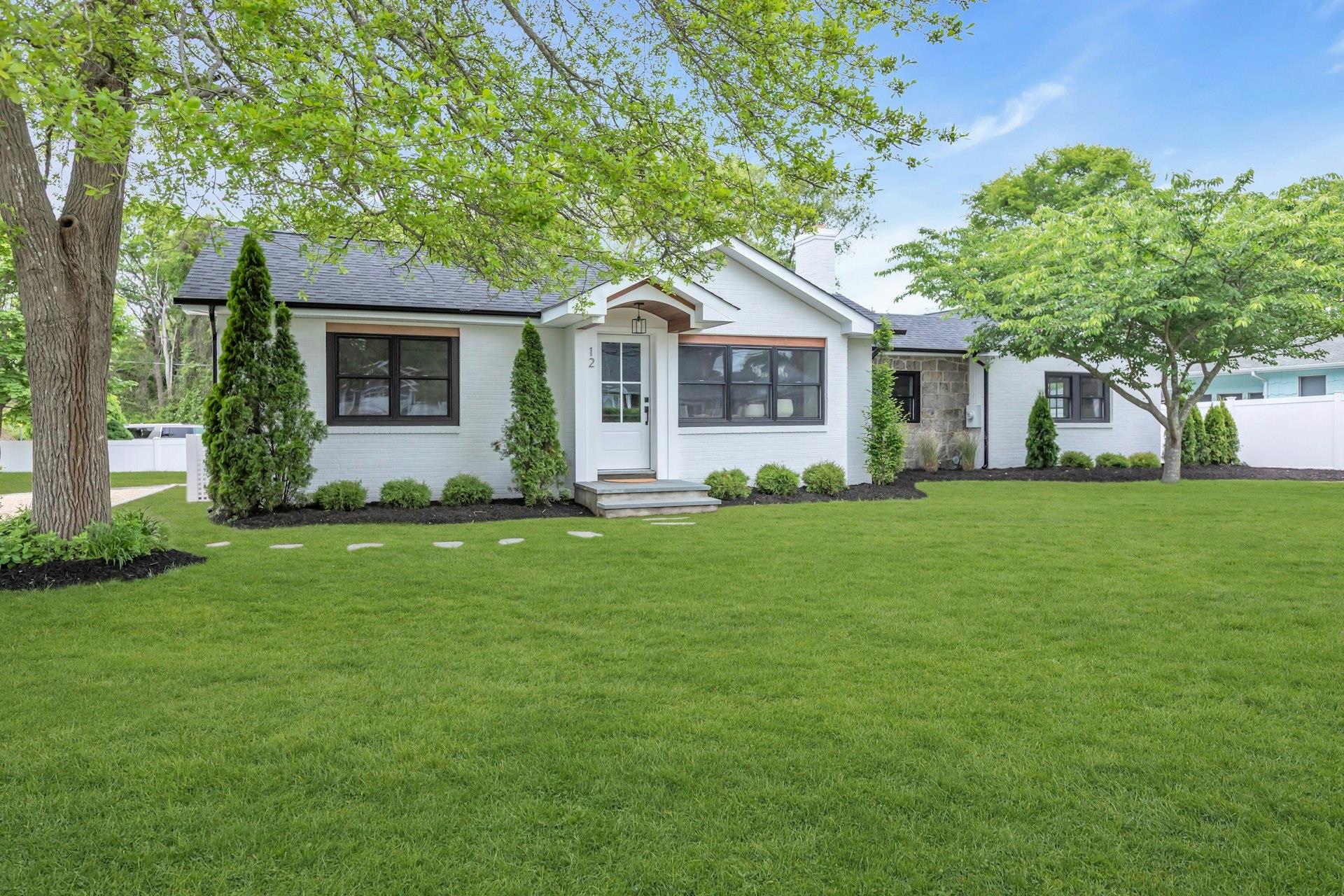 a front view of house with yard and green space