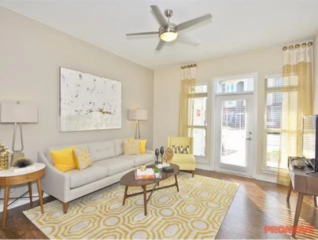 a living room with furniture and a large window