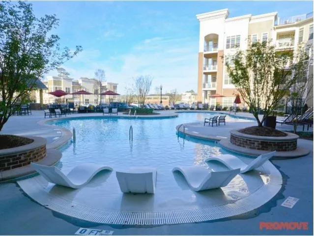 a view of a living room and kitchen with furniture