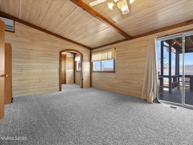 a view of room with window and a ceiling fan
