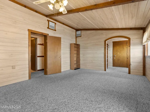 a view of a hallway with a chandelier fan