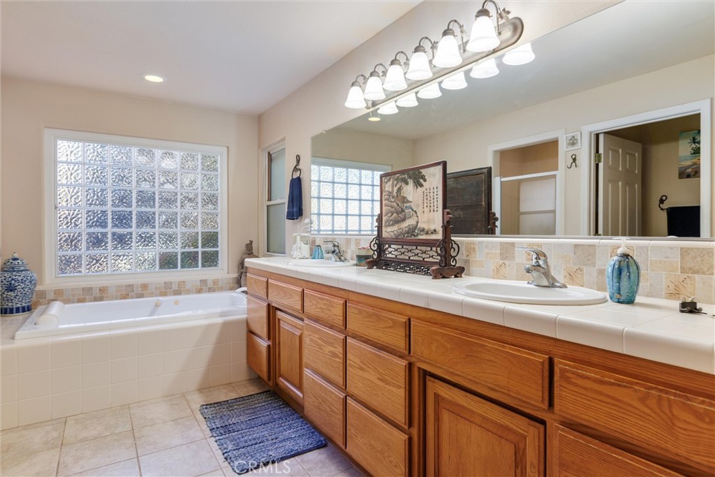 535 Charro Way Nipomo, CA 93444 - Photo 14 of 34 a spacious bathroom with a tub double sink and a large mirror