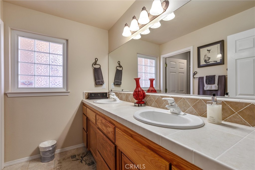 535 Charro Way Nipomo, CA 93444 - Photo 16 of 34 a bathroom with a sink a toilet and a mirror