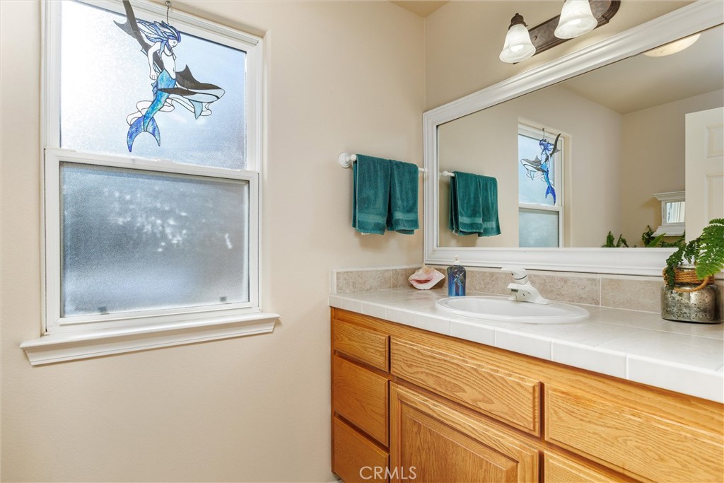 535 Charro Way Nipomo, CA 93444 - Photo 19 of 34 a bathroom with a sink mirror and vanity