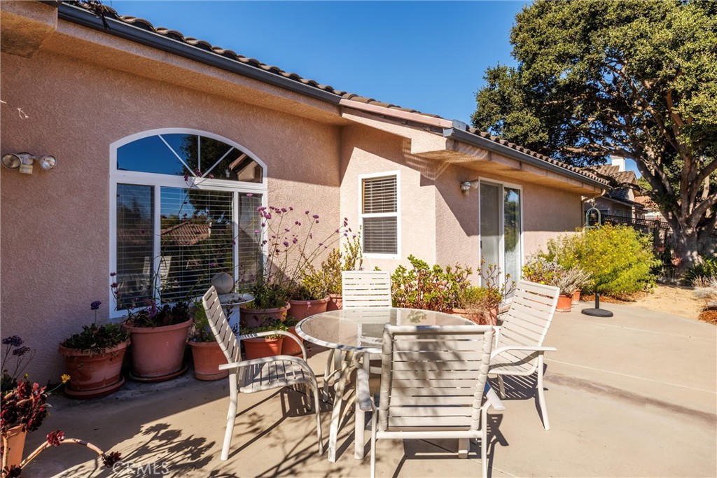 535 Charro Way Nipomo, CA 93444 - Photo 22 of 34 a view of a patio with table and chairs and potted plants