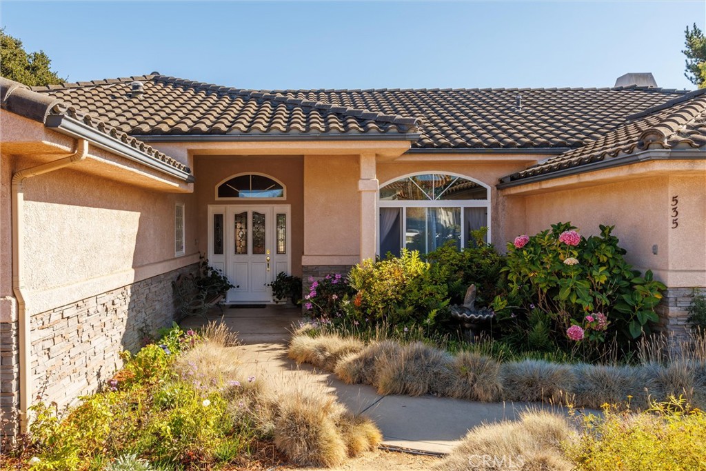 535 Charro Way Nipomo, CA 93444 - Photo 3 of 34 a front view of a house with a yard and a fountain