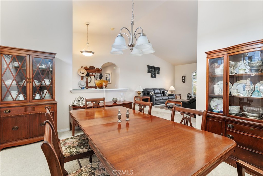 535 Charro Way Nipomo, CA 93444 - Photo 6 of 34 a dining room with wooden floor a chandelier a wooden table and chairs