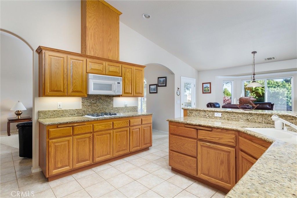 535 Charro Way Nipomo, CA 93444 - Photo 7 of 34 a kitchen with stainless steel appliances granite countertop a sink and cabinets