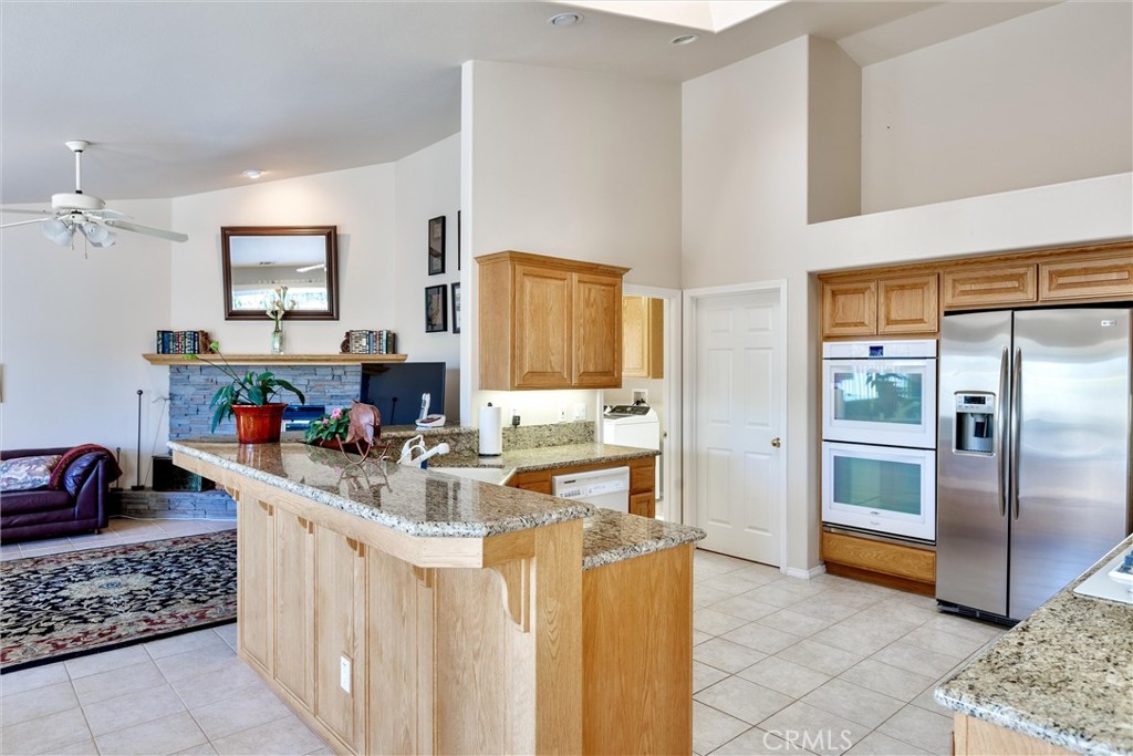 535 Charro Way Nipomo, CA 93444 - Photo 8 of 34 a kitchen with stainless steel appliances granite countertop a sink stove and refrigerator