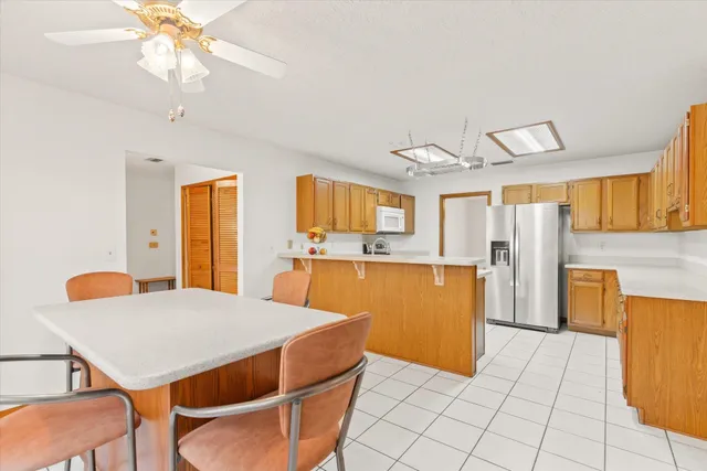 a large white kitchen with a large window