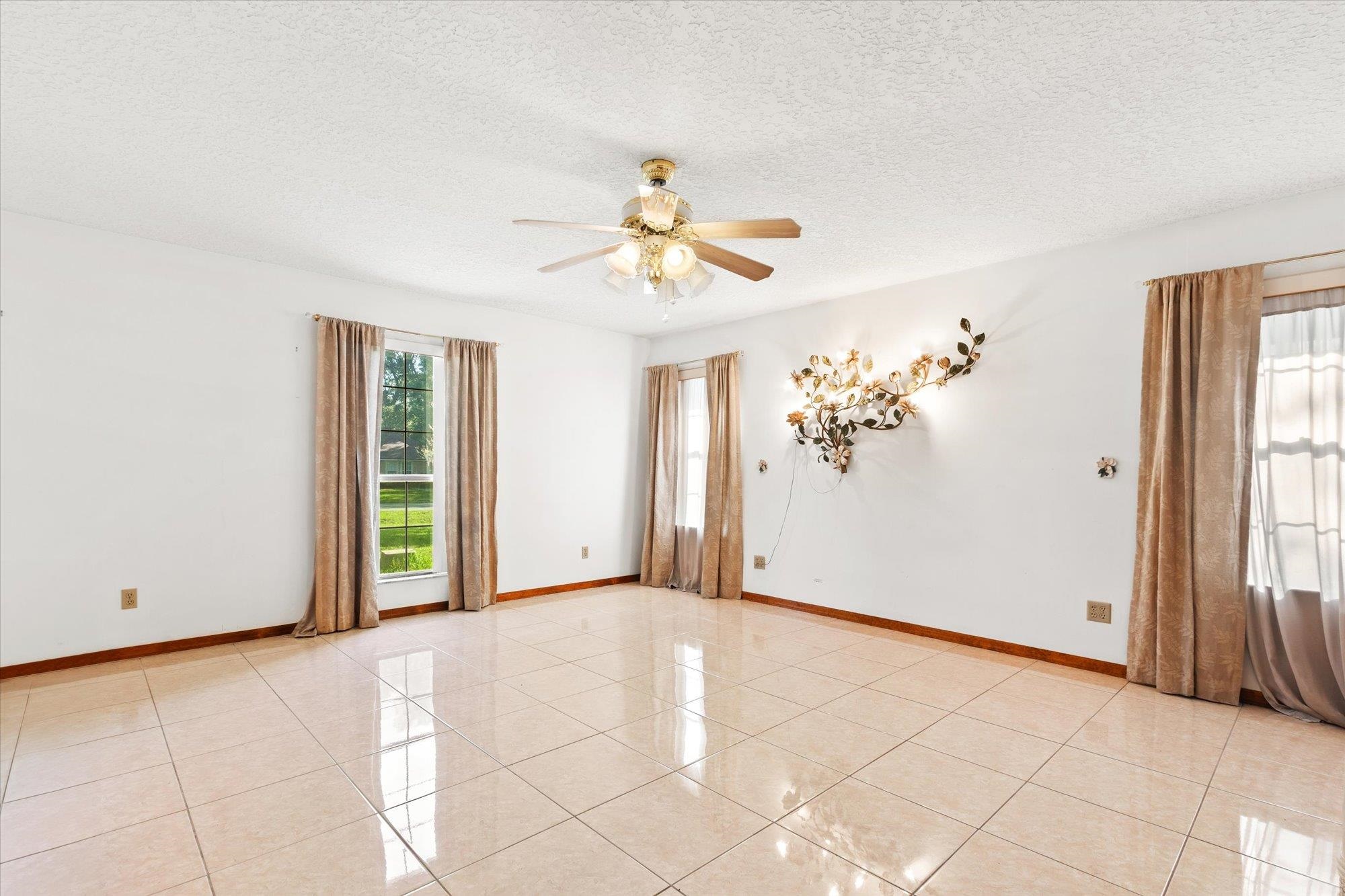 913 Chippewa Street St. Augustine, FL 32086 - Photo 19 of 56 a view of a livingroom with a chandelier fan and window