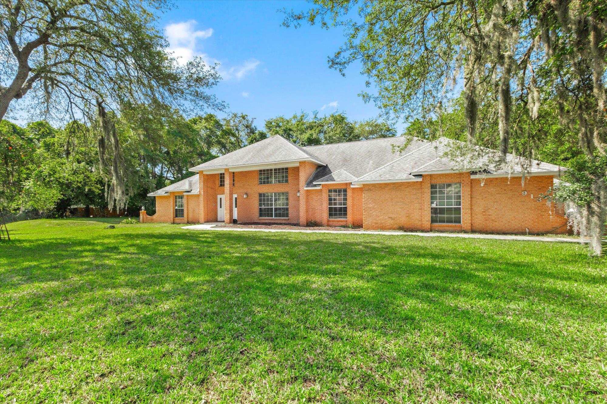 913 Chippewa Street St. Augustine, FL 32086 - Photo 2 of 56 a view of a house with a yard and sitting area