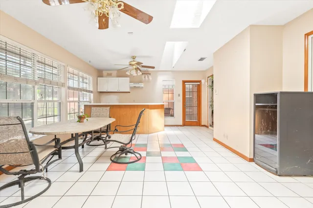 an empty room with a window and a fan