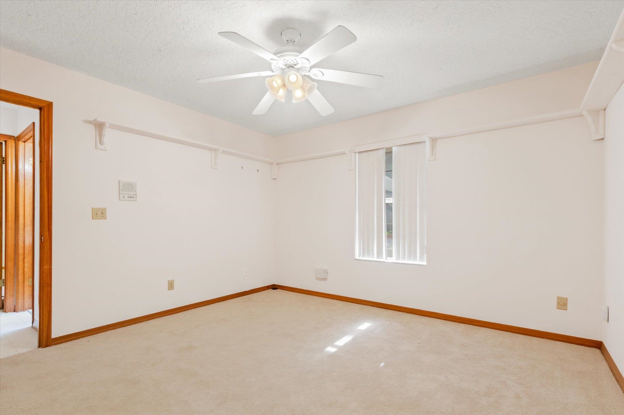 913 Chippewa Street St. Augustine, FL 32086 - Photo 36 of 56 an empty room with a window and a fan