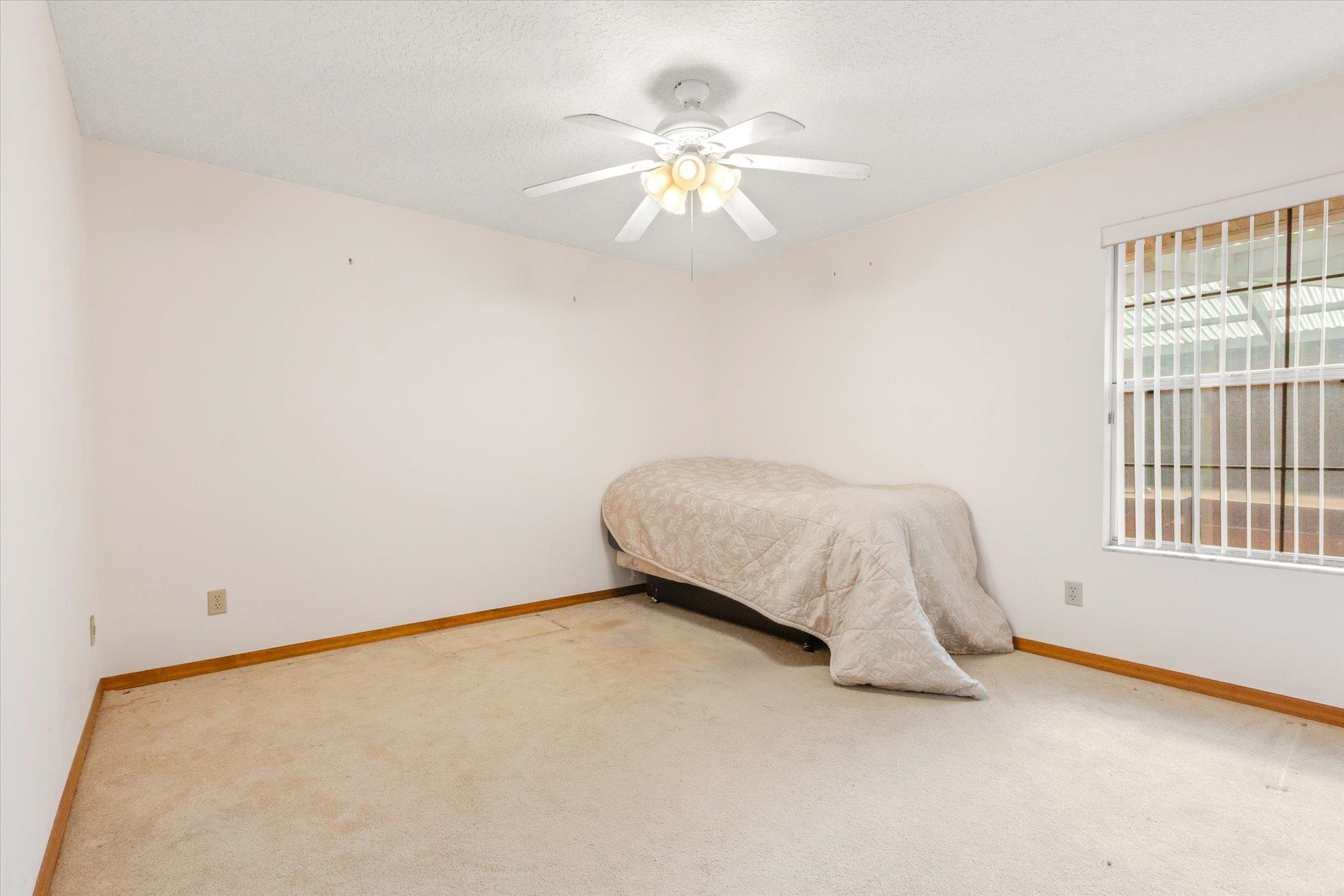 913 Chippewa Street St. Augustine, FL 32086 - Photo 38 of 56 a bedroom with a bed and a chandelier