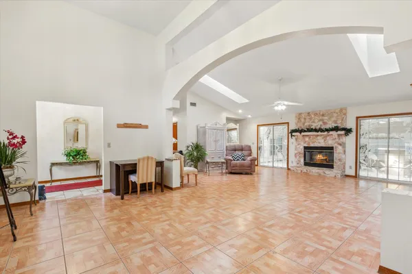 a living room with furniture a fireplace and a flat screen tv