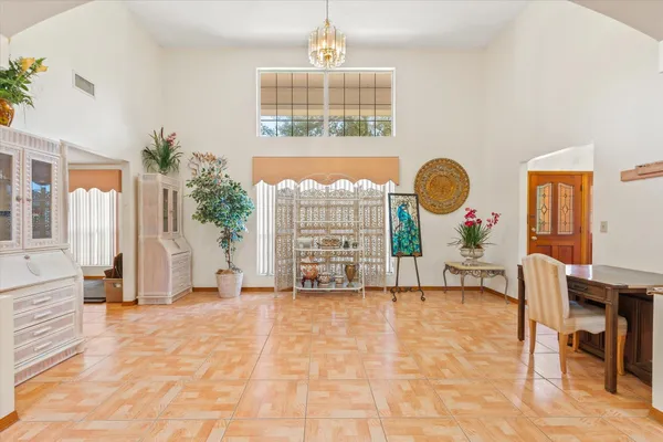 a view of an empty room with a fireplace and a window