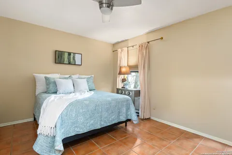 a bedroom with a bed and a night stand