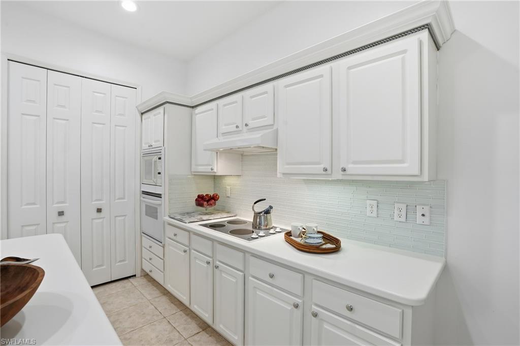 1737 Marsh Run Naples, FL 34109 - Photo 11 of 45 a kitchen with white cabinets and sink