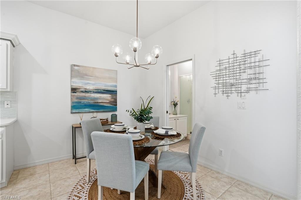 1737 Marsh Run Naples, FL 34109 - Photo 13 of 45 a view of a dining room with furniture and chandelier