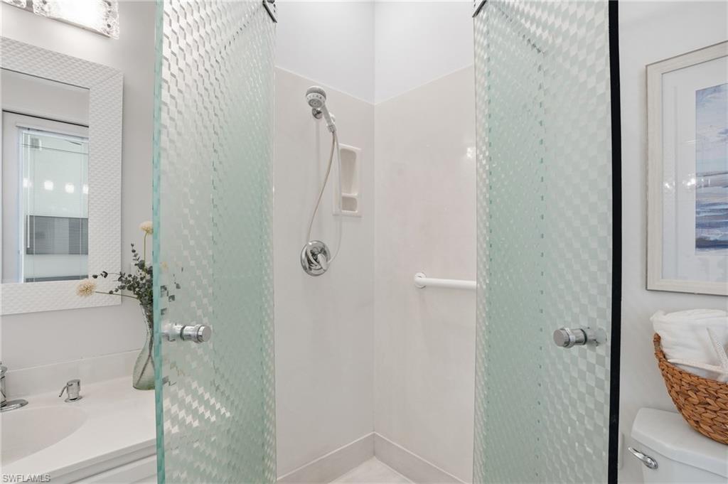 1737 Marsh Run Naples, FL 34109 - Photo 15 of 45 a bathroom with a bathtub and shower