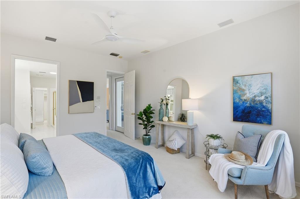 1737 Marsh Run Naples, FL 34109 - Photo 19 of 45 a bedroom with furniture and a large mirror