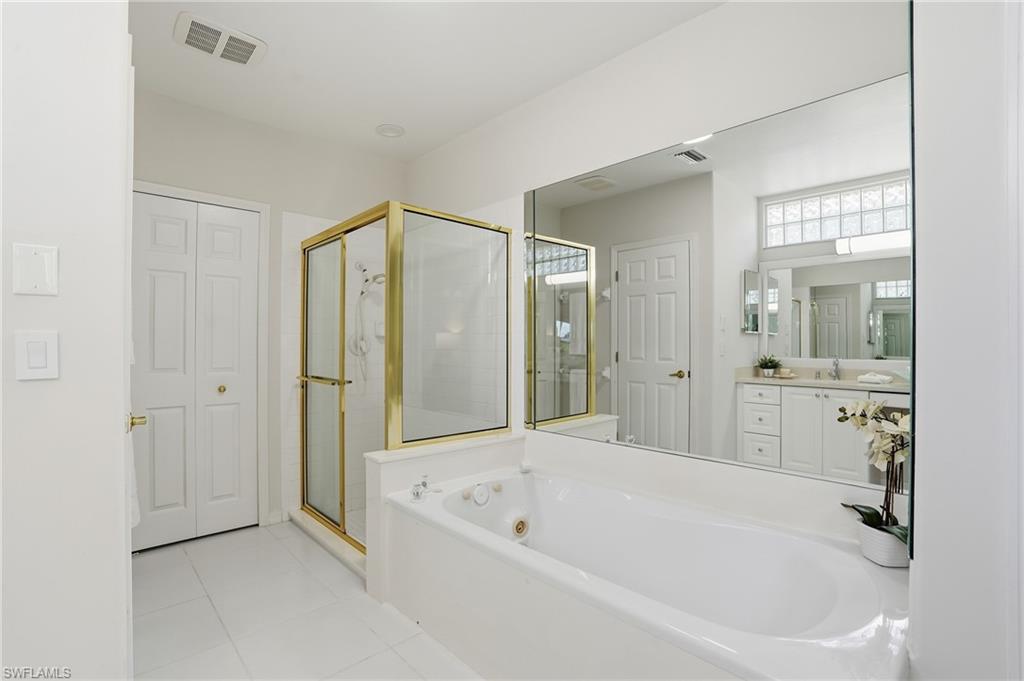 1737 Marsh Run Naples, FL 34109 - Photo 20 of 45 a bathroom with a bathtub and a shower