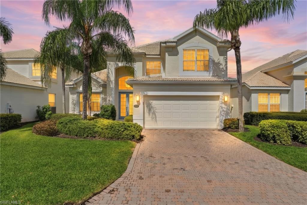 1737 Marsh Run Naples, FL 34109 - Photo 2 of 45 a front view of a house with a yard and garage