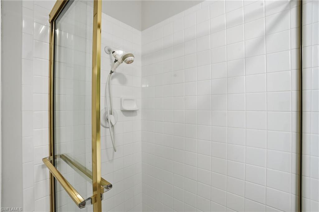 1737 Marsh Run Naples, FL 34109 - Photo 21 of 45 a bathroom with a glass shower door